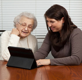 Senior Playing Game with Touch Screen Tablet PC